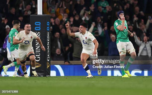 Marcus Smith of England celebrates scoring the winning drop goal with teammates during the Guinness Six Nations 2024 match between England and...