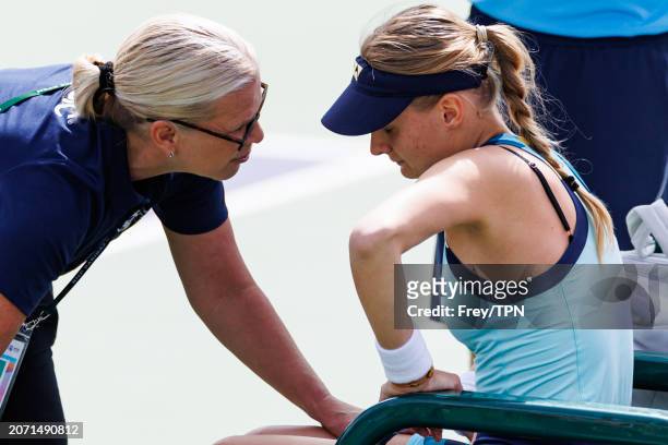Dayana Yastremska of Russia receives medical attention for a stomach injury during her match against Emma Raducanu of Great Britain in the second...