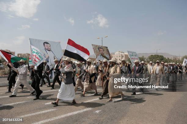 Yemen's Houthi followers from state servants carry weapons as they take part in a rally and parade held against the U.S.-led aerial attacks on Yemen...