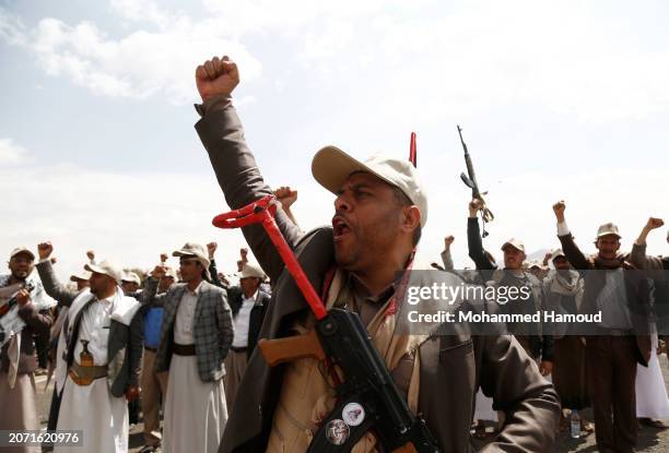 Yemen's Houthi followers from state servants carry weapons and chant slogans as they take part in a rally and parade held against the U.S.-led aerial...