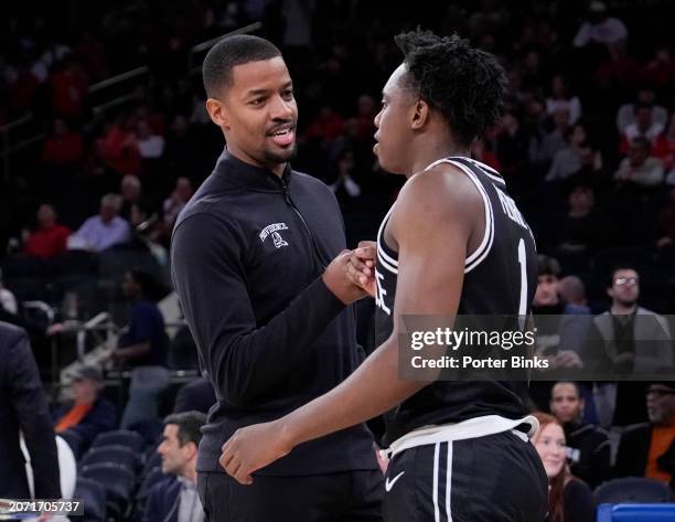 Jayden Pierre of the Providence Friars with head coach Kim English of the Providence Friars during pre-game introductions before a game against the...