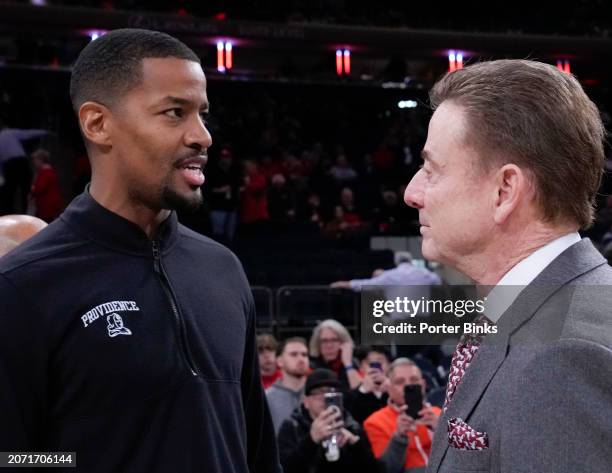 Head coach Kim English of the Providence Friars talks with head coach Rick Pitino of the St. John's Red Storm before their game at Madison Square...