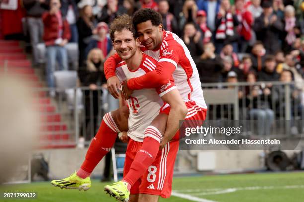 Serge Gnabry of Bayern Munich celebrates scoring his team's sixth goal with teammate Leon Goretzka during the Bundesliga match between FC Bayern...