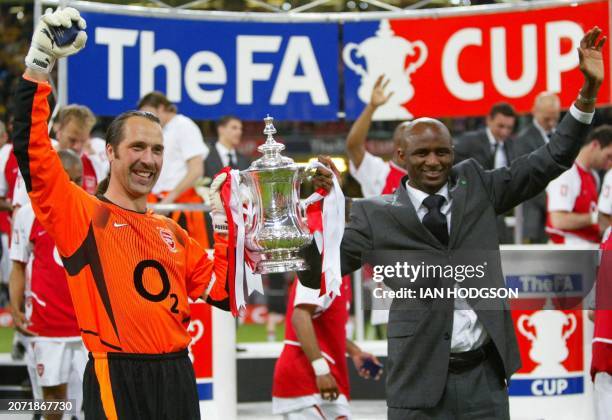 Arsenal's match captain and goalkeeper David Seaman lifts the FA Cup trophy with injured captain Patrick Viera after the final against Southampton at...