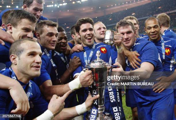 The French team celebrate with the trophy after beating England and winning the 6 Nations rugby championship at the Stade de France in Saint-Denis,...