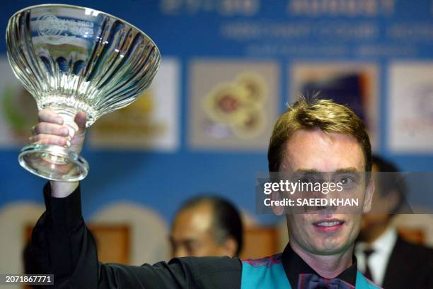 Ken Doherty of Ireland lifts a trophy after defeating his Hong Kong opponent Marco Fu in the Snooker final of the Thailand 2003 Europe Vs Asia...