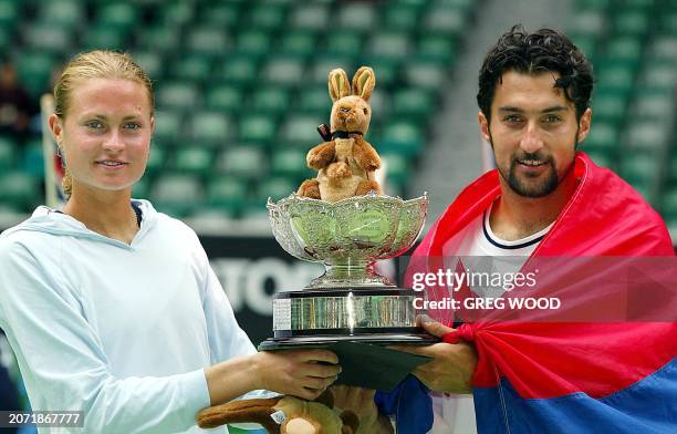 Nenad Zimonjic of Servia holds up the winners' trophy with partner Elena Bovina of Russia following their victory in the mixed doubles final at the...