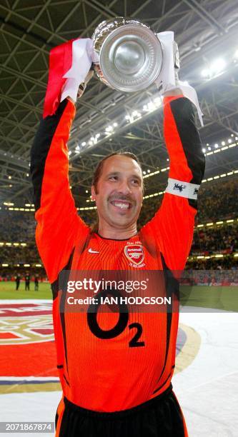 Arsenal's match captain and keeper David Seaman lifts the FA Cup trophy after the final against Southampton at the Millennium Stadium in Cardiff 17...