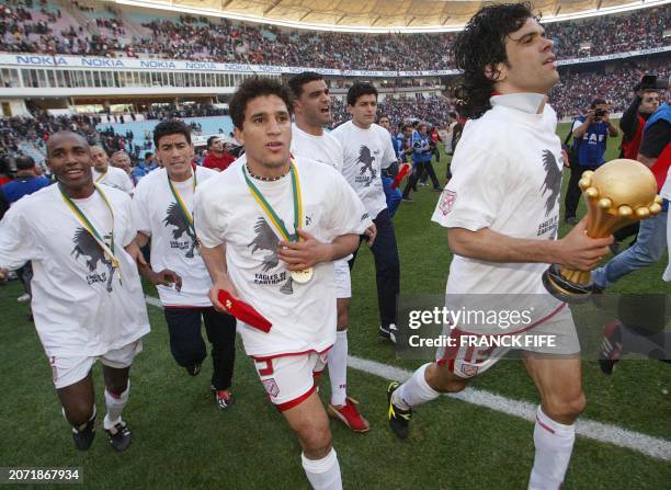 Unidentified players of the Tunisian national football team celebrate with the trophy after defeating Morocco 2-1 in the final match of the 2004...