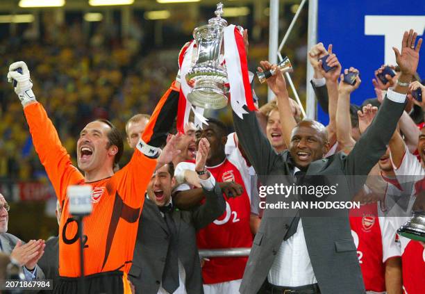 Arsenal's match captain and keeper David Seaman lifts the FA Cup trophy with injured captain Patrick Viera after the final against Southampton at the...