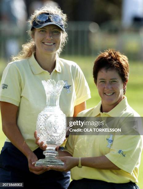 European team captain Catrin Nilsmark of Sweden and vice captain Alison Nicholas of Britain display the trophy after the team won the Solheim Cup...