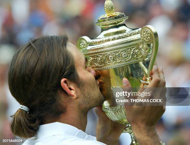 Roger Federer of Switzerland kisses the Wimbledon trophy after defeating Mark Philippoussis of Australia in their Men's Final match at the Wimbledon...