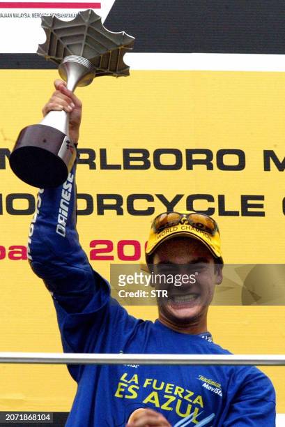 Daniel Pedrosa of Spain raises his trophy after winning 125cc race in the Malaysian Motorcycle Grand Prix in Sepang 12 October 2003. Pedrosa won the...
