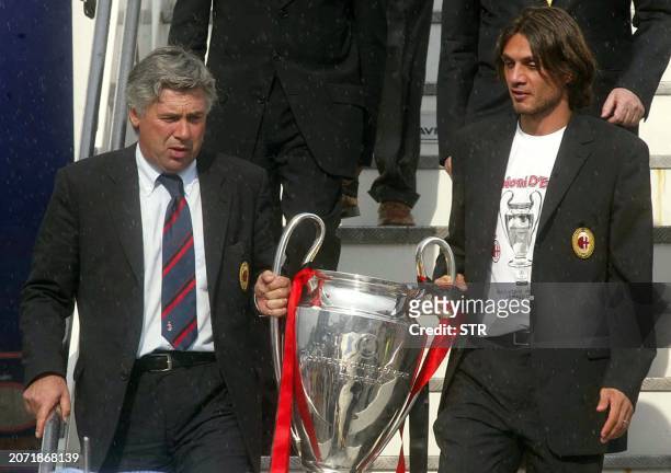 Milan coach Carlo Ancelotti descends from the plane together with his captain Paolo Maldini carrying the Champions League Cup, won 28 MAY in the...