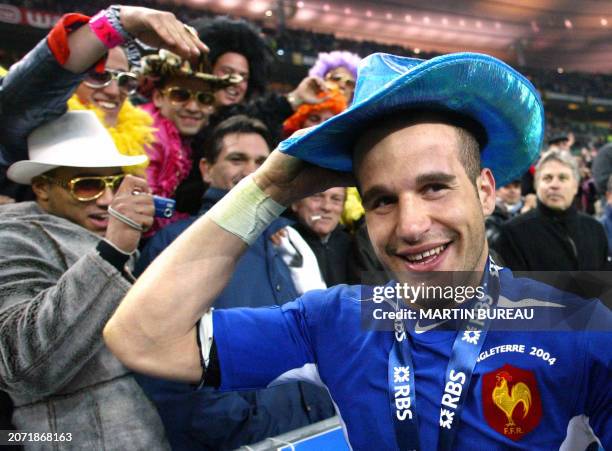 France's Frederic Michalak celebrates with fans after beating England and winning the 6 Nations championship at the Stade de France in Saint-Denis,...