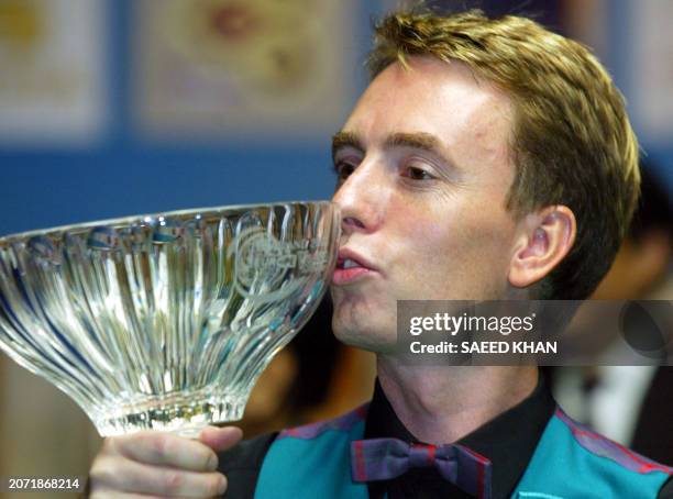 Ken Doherty of Ireland kisses a trophy after defeating his Hong Kong opponent Marco Fu in the Snooker final of the Thailand 2003 Europe Vs Asia...