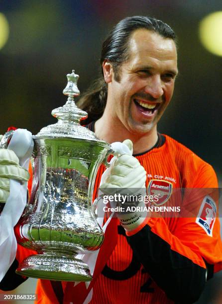 Arsenal's Captain and goalkeeper David Seaman celebrates with the FA Cup after beating Southampton 1-0 in the final at The Millenium Stadium in...