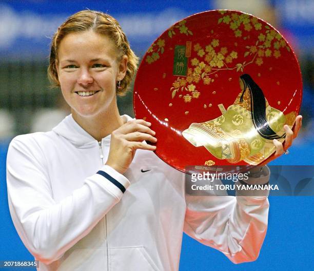 Lindsay Davenport of the US smiles as she holds the winner's trophy during an awards ceremony following the final match against compatriot Monica...