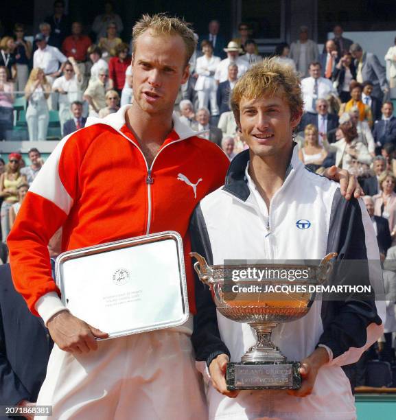 Spain's Juan Carlos Ferrero and his Dutch opponent Martin Verkerk stand with their trophies, 08 June 2003 in Paris, following their Roland Garros...