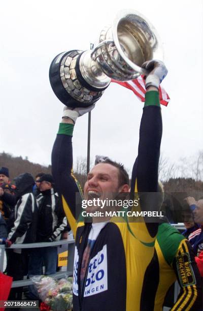 Carsten Embach of the Germany-1 Bobsleigh team hoists the Martineau Cup after his team took first place overall in the 2003 Verizon FIBT Men's...