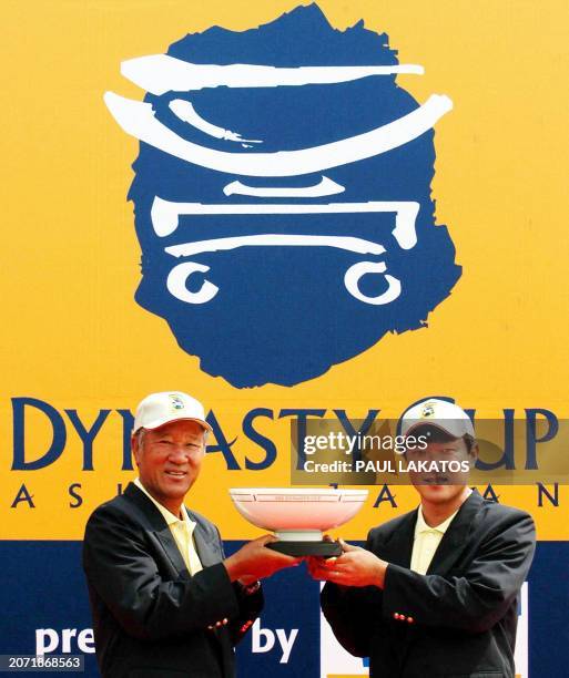 Isao Aoki, non playing Captain of Japan, and Nobuhito Sato also of Japan with the Phoenix Dynasty Cup trophy at the Mission Hills Golf Club,...