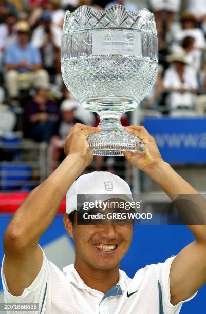 Hyung-Taik Lee of Korea holds up the trophy after defeating Juan Carlos Ferrero of Spain in the men's final of the Sydney International tennis...