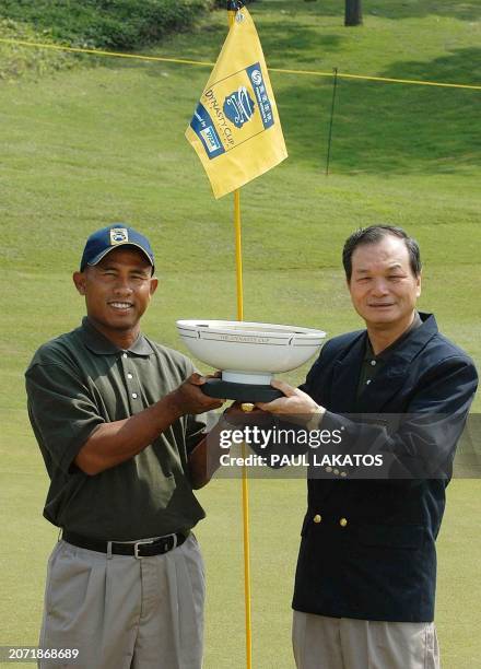 Asian PGA player Thongchai Jaidee of Thailand and Hseih Min-nan of Chinese Taipei, non playing Captain of Asia with the Phoenix Dynasty Cup trophy at...