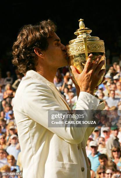 Switzerland's Roger Federer celebrates his fourth consecutive Wimbledon Championships title after beating Spain's Rafael Nadal at the Wimbledon...