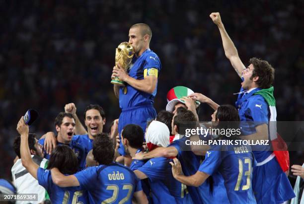 Italian captain Fabio Cannavaro holds the World Cup trophy amid teammates after the end of the World Cup 2006 final football game Italy vs.France, 09...