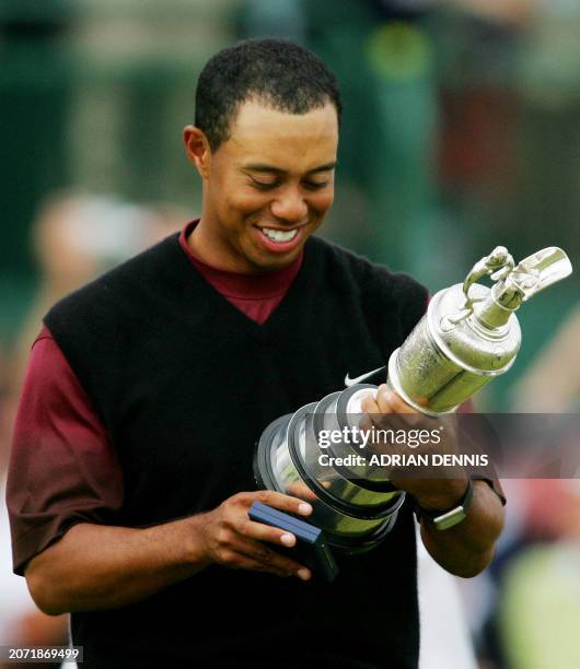 Tiger Woods of the US looks at his name on the Claret Jug after winning the 134th Open Championship on the Old Course in St. Andrews, Scotland, 17...