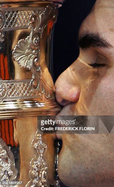 Swiss's Roger Federer kisses the trophy after winning his final match against Chilian's Fernando Gonzales at the Swiss Indoors ATP tennis tournament,...