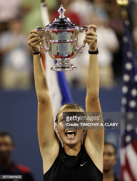 Maria Sharapova of Russia holds her trophy after winning the woman's final match against Justine Henin-Hardenne of Belguim at the 2006 US Open at the...