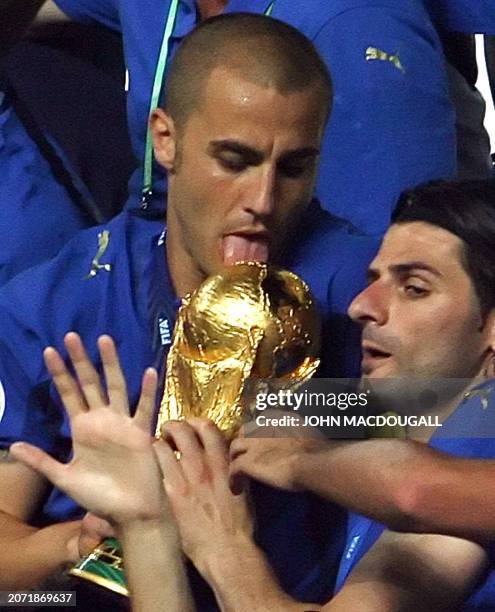 Italian defender Fabio Cannavaro licks the trophy during the World Cup 2006 final football game Italy vs.France, 09 July 2006 at Berlin stadium....