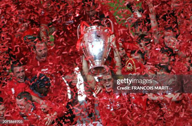 Liverpool's captain Steven Gerrard holds the throphy surrounded by teammates at the end of the UEFA Champions league football final AC Milan vs...