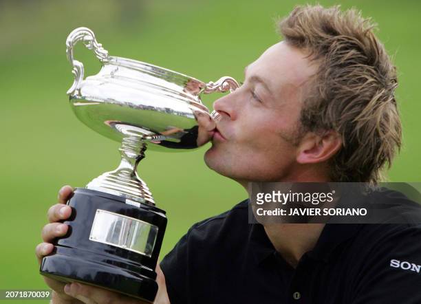 France's Raphael Jacquelin kisses his trophy after winning the Madrid Open at the Club de Campo in Madrid, 16 October 2005. Jacquelin finally ended...