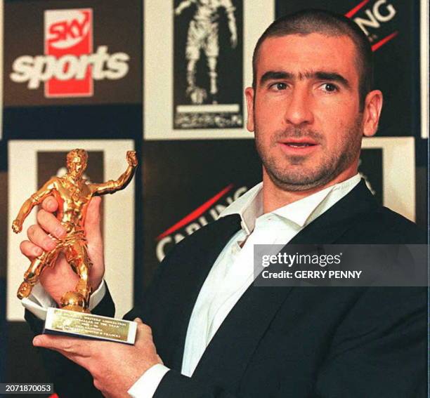 Manchester United's soccer star Eric Cantona of France holds the Footballer of the Year trophy awarded by the Football Writers Association, before a...