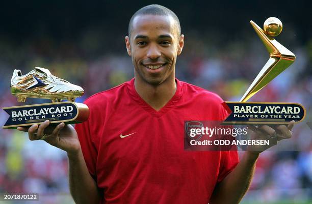 Arsenal's Thierry Henry with the Golden Boot and Player of the Year award presented before a testimonial football match for team-mate Martin Keown at...