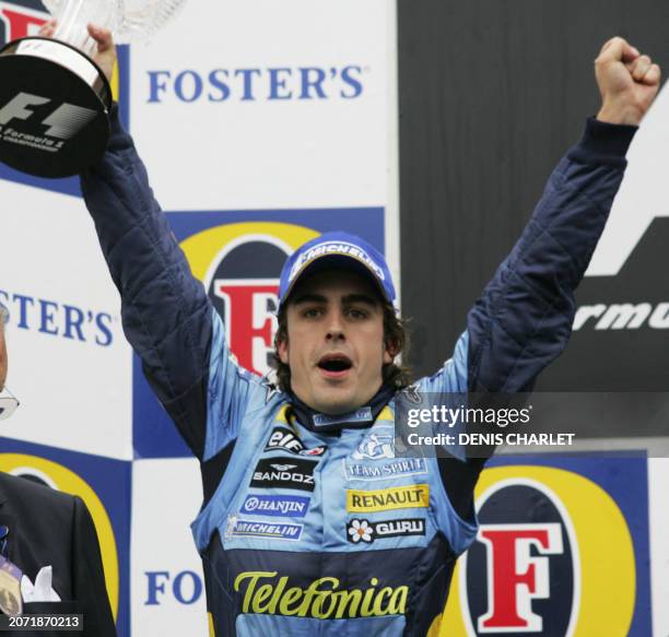 Renault Spanish driver Fernando Alonso jubilates on the podium of the Spa-Francorchamps racetrack after the Belgian Grand Prix, 11 September 2005 in...