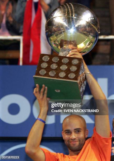 James Blake of the United States lifts the Stockholm Open trophy after his victory against Paradorn Srichaphan of Thailand in the final of the...