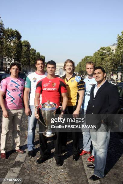 French rugbyman Nicolas Jeanjean poses with French championship Toulouse 's trophy, on the Champs-Elysees avenue in Paris, 11 October 2005, before...