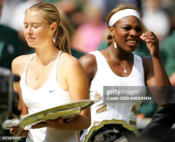 Maria Sharapova of Russia and Serena Williams of the US carry their trophies after their ladies final match at the 118th Wimbledon Tennis...