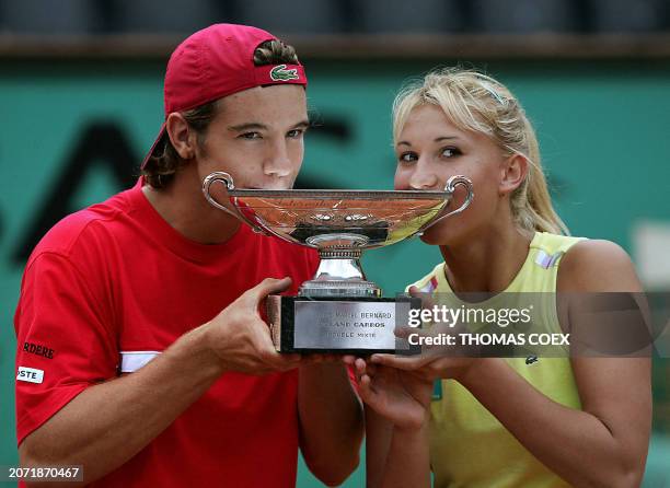 French Tatiana Golovin and Richard Gasquet celebrate with the cup after defeating Zimbabwe's Cara Black and Wayne Black in their mixed doubles final...