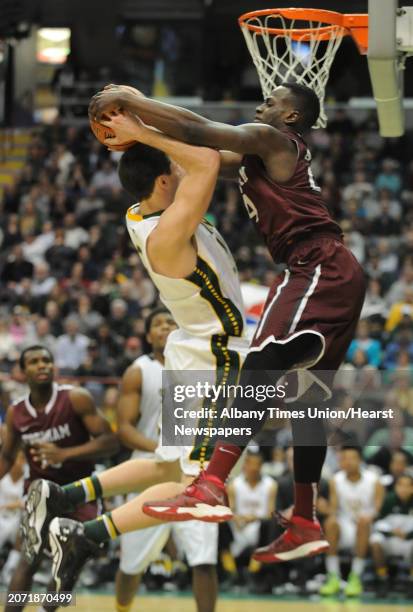 Siena's Brett Bisping gets fouled by Fordham's Bryan Smith during a basketball game at the Times Union Center on Monday, Dec. 30, 2013 in Albany, N.Y.