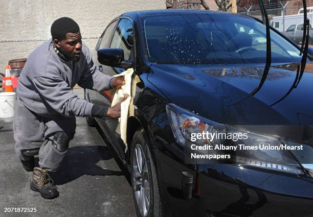 Tony Carter of Troy dries a car after washing it on Monday, March 31, 2014 in Albany, N.Y. Tony owns a pressure washing and detailing business called...