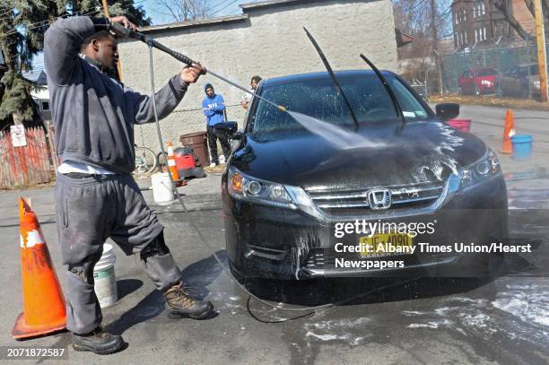 Tony Carter of Troy uses a power washer on a car on Monday, March 31, 2014 in Albany, N.Y. Tony owns a pressure washing and detailing business called...