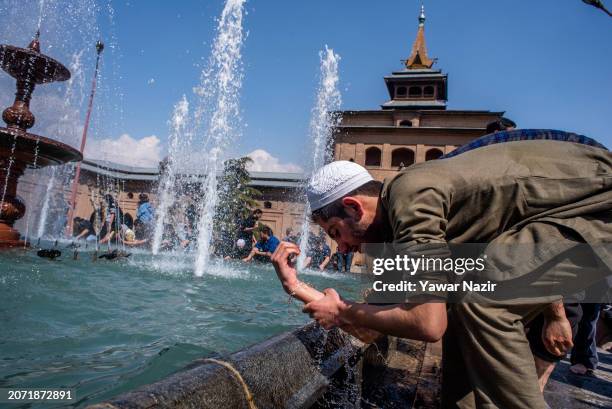 Kashmiri Muslim man performs ablution at a pond before offering prayers inside the Grand Mosque on the first day of the holy Islamic month of Ramadan...