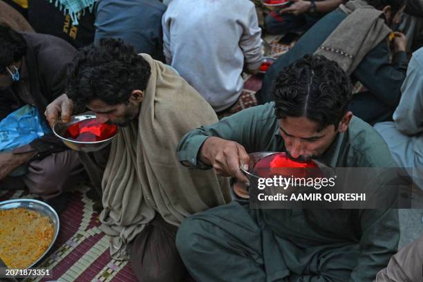 Muslim devotees break their fast along a street on the first day of the holy month of Ramadan in Rawalpindi on March 12, 2024.
