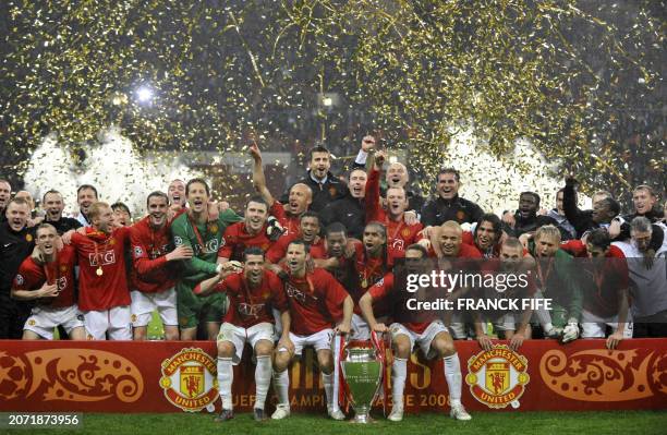 Manchester United players pose with the trophy after beating Chelsea in the final of the Champions League football match at the Luzhniki stadium in...