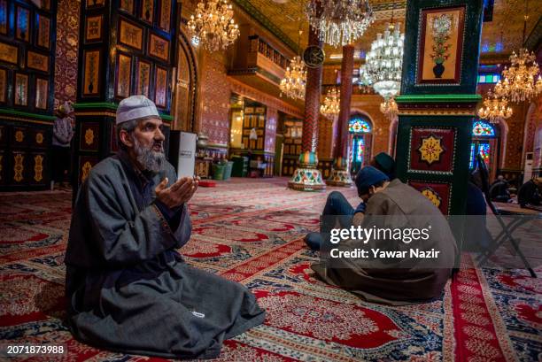 An elderly Kashmiri Muslim prays, on the first day of the holy Islamic month of Ramadan, at the Dastgeer Sahib shrine, dedicated to the 11th-century...