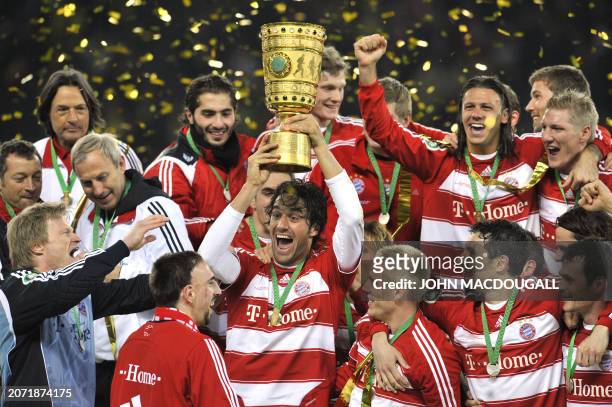 Bayern Munich's Italian striker Luca Toni lifts the trophy as Bayern Munich's goalkeeper Oliver Kahn , French midfielder Franck Ribery and other...